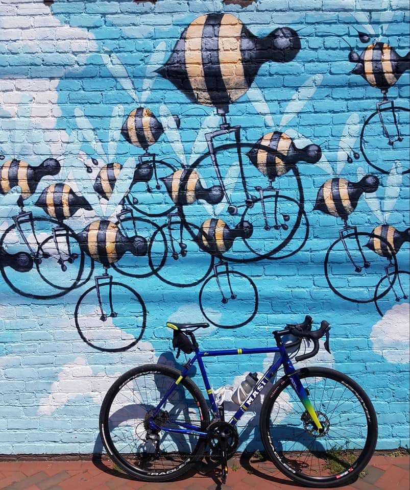 Jay's bike in front of urban art.